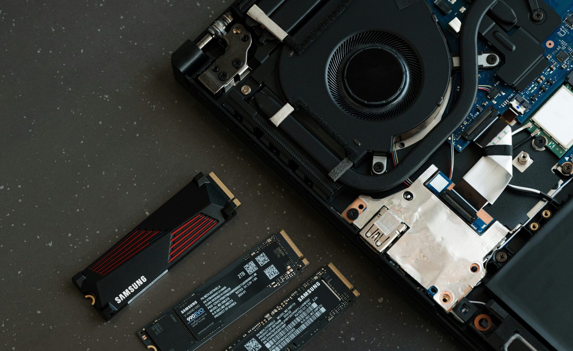 A broken laptop computer sitting on top of a table